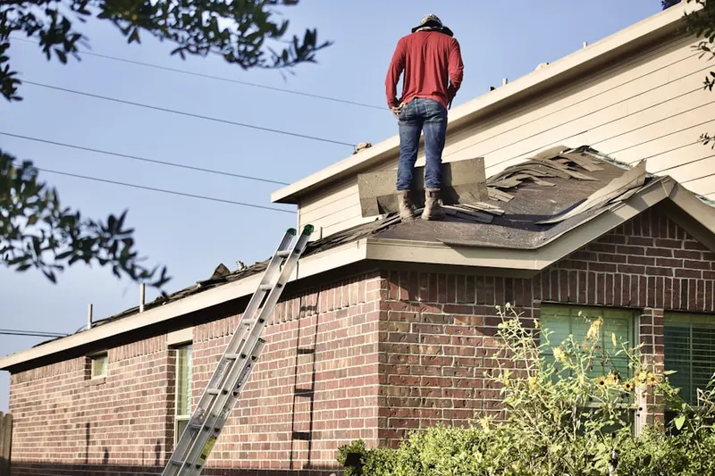 Professional roofer working on a residential roof in Brokenburg